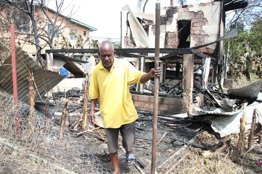 Fire guts La Romaine home; residents attack migrant woman