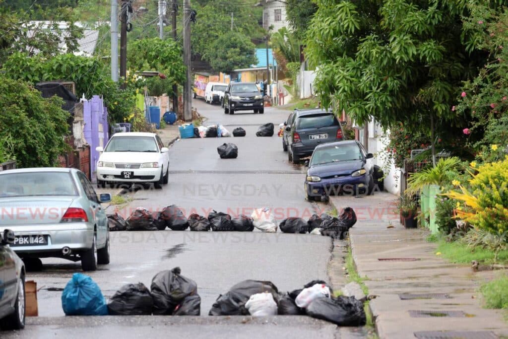St James residents protest garbage pile-up