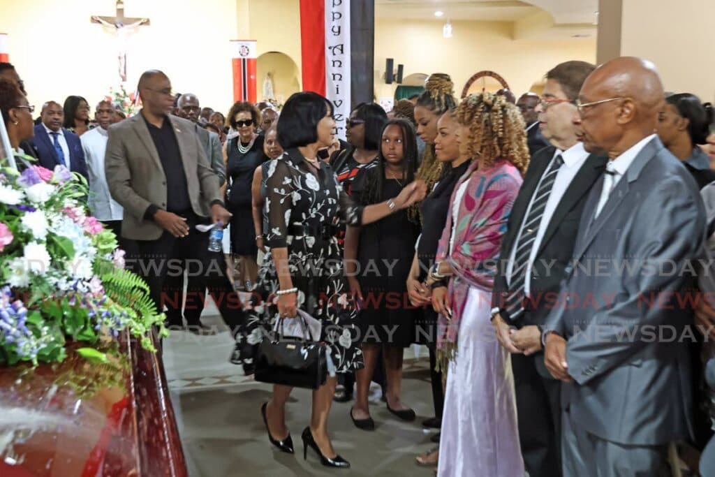 Mourners recall slain doctor's endless love, service