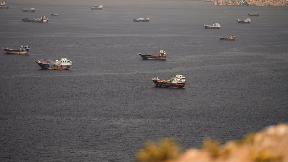 Traffic flows through Hormuz as U.S.-Iran deal takes effect, questions remain