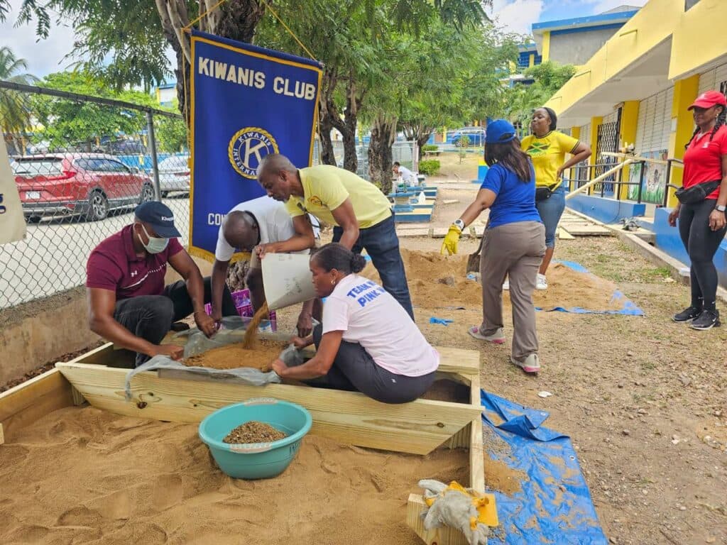 Kiwanians join K-Kids to plant fruit trees